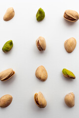 Pattern of roasted pistachios isolated on white background.