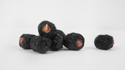 ajwa dates in a white background