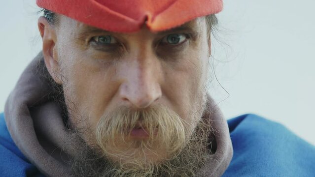 Close-up portrait of a charismatic man dressed as a medieval warrior with a beard and mustache