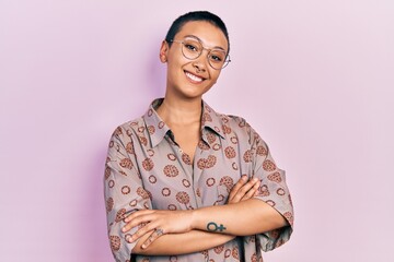 Beautiful hispanic woman with short hair wearing glasses happy face smiling with crossed arms...