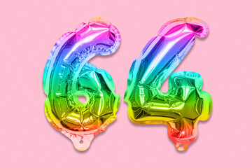 Rainbow foil balloon number, digit sixty four on a pink background. Birthday greeting card with inscription 64. Top view. Numerical digit. Celebration event, template.