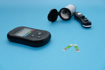 Blood glucose meter, test strips and syringe for monitoring diabetes mellitus.