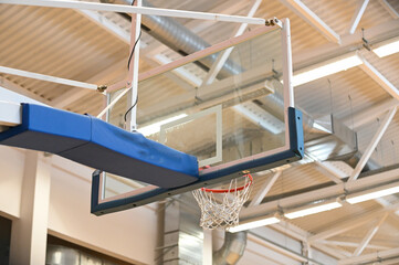 Fototapeta premium Basketball hoop close up in old school sport gym hall