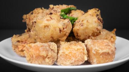 full shot variation of indonesian fritters in a black background