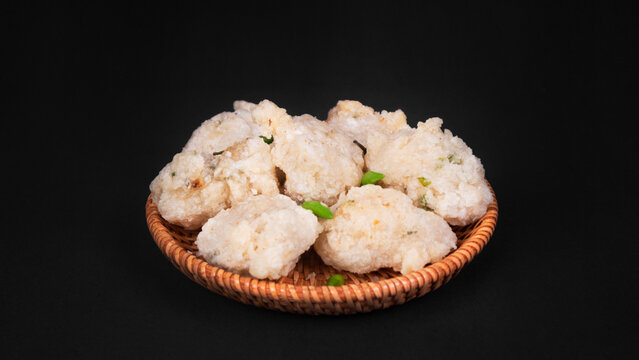 full shot a bowl of fried tapioka flour in a black background