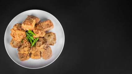 top view variation of indonesian fritters in a black background