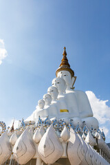 Five big white buddha sculptures with mountain and white cloud with blue sky phasornkaew temple in khao kho Phetchabun Thailand.
