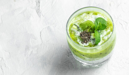Chia pudding in a glass. Healthy breakfast. chia pudding with kiwi on light background. Long banner format. top view