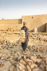 a poor laborer working hard in extreme heat on a construction site