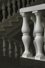 Balusters in the decoration of the veranda railings. An architectural element made of wood. An old manor outside the city.