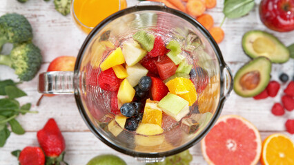 Mixing pieces of fruits in blender, top view.