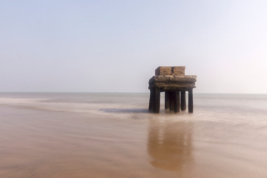Black and white long exposure photo of a very old architectural structure on sea beach at Digha, West Bengal.