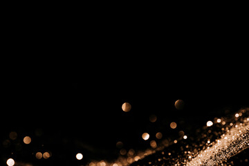 Gold color sparkle roll down on black background.