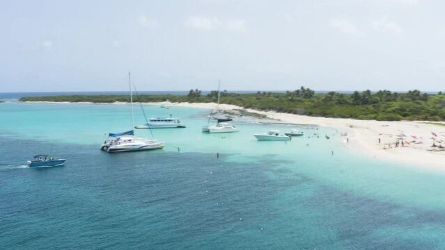 AERIAL - People on boats on clear waters, Cayo Icacos, Puerto Rico, spinning shot