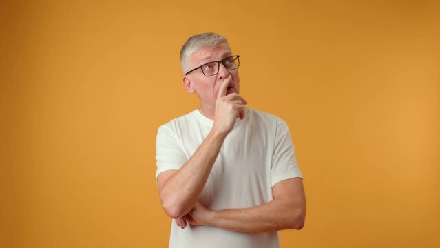 Middle age handsome grey-haired man thinking about question, doubtful expression