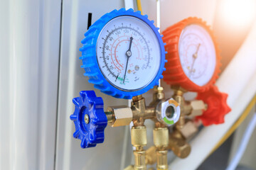 Manifold gauge lowside is blue and high side is red is used for vaccuming and refrigerantcharging the air conditioner is being used and displays the pressure inside the system. - Powered by Adobe