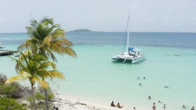 AERIAL - People, catamaran boat, turquoise waters, Cayo Icacos, Puerto Rico, reverse