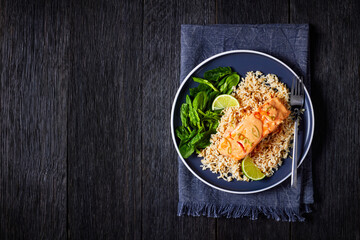 portion of cooked Salmon with rice and greens