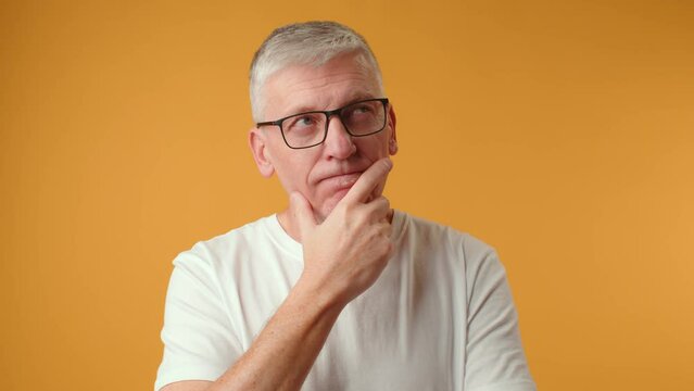 Middle age handsome grey-haired man thinking about question, doubtful expression