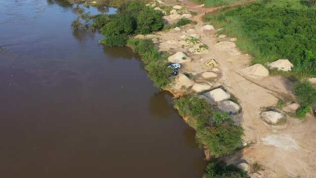 Aerial Sewa River diamond mining area Sierra Leone circle part 2. West Africa suffers extreme poverty and hunger. Forest jungle landscape environment. Congested crowded homes tropical climate.