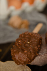 Homemade cakes in chocolate icing with nuts on the table among the ingredients
