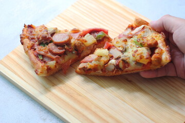 2 pizzas served on a white wooden tray.