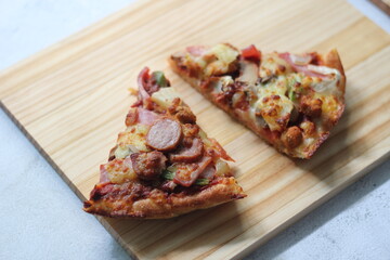 2 pizzas served on a white wooden tray.
