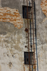 Exterior of old brick building with rusted fire escape