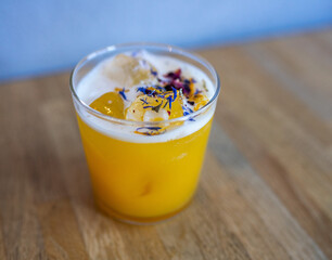 summer cocktail with flowers on the wooden table