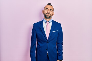 Young hispanic man wearing business suit and tie depressed and worry for distress, crying angry and afraid. sad expression.