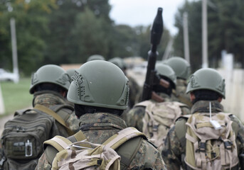 Soldiers with antitank grenade launcher from the back.