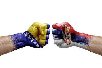 Two hands punch to each others on white background. Country flags painted fists, conflict crisis...