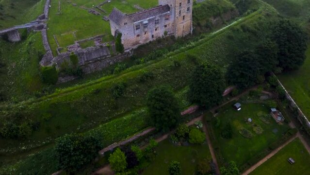 Drone pan of medieval Helmsley Castle, town and walled garden at dusk