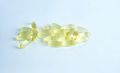 omega capsules on a white background are laid out in the shape of a fish