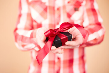 Close up photo of present box in male hands. Man holding gift box. Valentine's day. Birthday or Holidays concept. Copy space