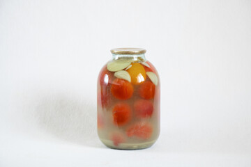 canned homemade tomatoes in jars on a white background close up