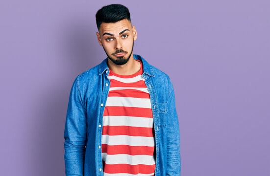 Young hispanic man with beard wearing casual denim jacket depressed and worry for distress, crying angry and afraid. sad expression.