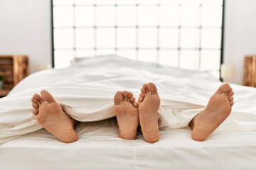 Two hispanic men couple lying on bed at bedroom
