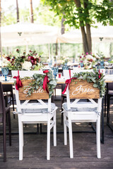 banquet table is decorated with plates, cutlery, glasses, candles and flower arrangements