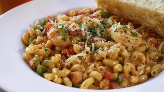 A decadent plate of creamy seafood macaroni pasta, close up slider 4K