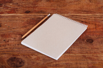 Organic notebook on the wooden background. Zero waste concept, copy space