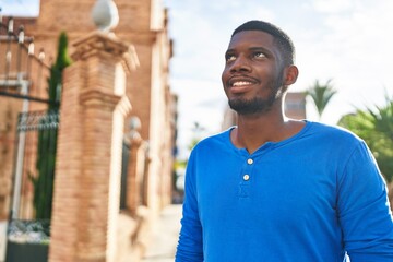 Fototapeta premium Young african american man smiling confident standing at street