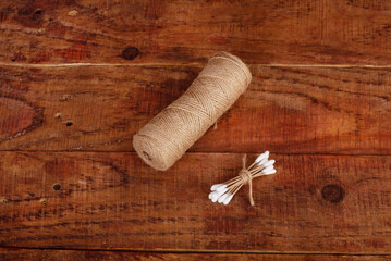Reusable bamboo swab and bundle winding in the form of a heart as a symbol of love for nature on wooden background