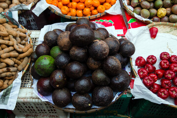 Mixed fresh tropical fruits on street market. Local morning market in Luang Prabang, Laos.