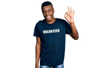 Young african american man wearing volunteer t shirt smiling positive doing ok sign with hand and...