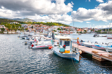 Fototapeta na wymiar Fishing boats moored at the pier of a Greek town Neos Marmaras