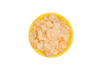 potato chips on yellow plate isolated on white background. view from above