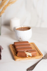 Glazed curds in caramel on a wooden board. Different dessert with glazed cheese.
