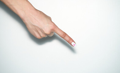 Pointing gesture. Female hand shows index finger with rose triangle manicure. Symbol of lesbian, gay, bisexual, transgender and queer pride isolated on white background.