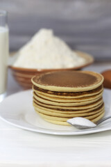Pancakes with ingredients: flour, eggs, milk, soda